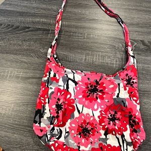 Thirty-one crossbody reversible bag in red, black, and white.